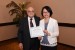 Dr. Nagib Callaos, General Chair, giving Professor Yen-Fen Lo the best paper award certificate of the session "Academic Globalization and Inter-Cultural Communication I ." The title of the awarded paper is "A Case Study of Synchronous Distance Learning Between Shih Chien University and Beijing Foreign Studies University."
